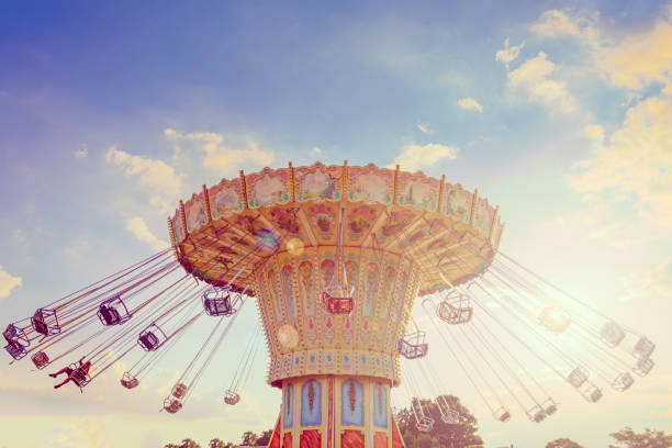 wave swinger corousel ride against blue sky, vintage filter effects - carnival amusement park amusement park ride traditional festival imagens e fotografias de stock