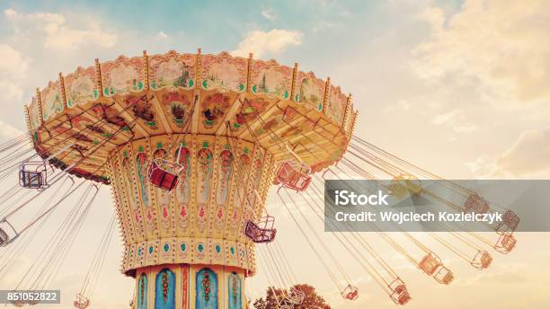 Carousel Ride Spins Fast In The Air At Sunset Vintage Filter Effects A Swinging Carousel Fair Ride At Dusk Stock Photo - Download Image Now