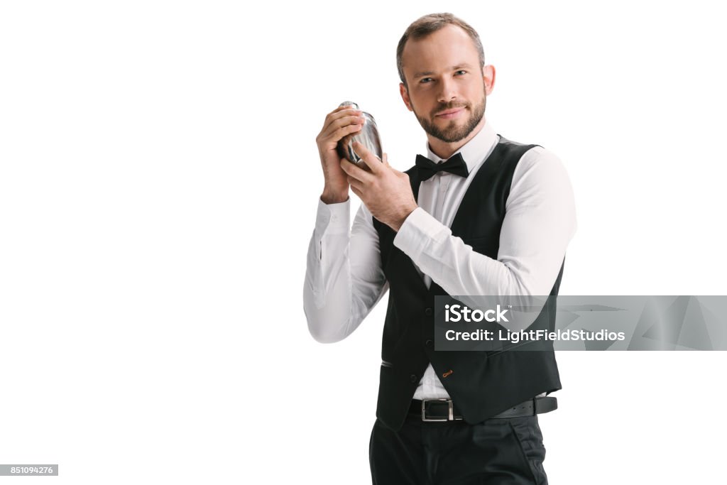 handsome bartender with shaker handsome smiling bartender with classical metal shaker isolated on white Bartender Stock Photo