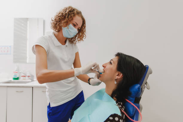 istock A female dentist is installing in the patient's mouth a device for making a molded tooth 851094406