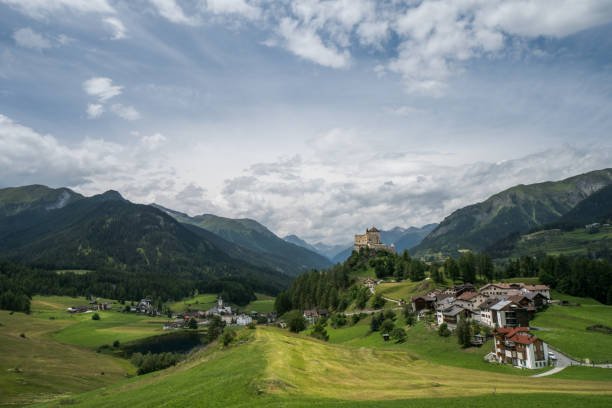 view of tarasp village and castle in the alps of switzerland - castle engadine alps lake water imagens e fotografias de stock