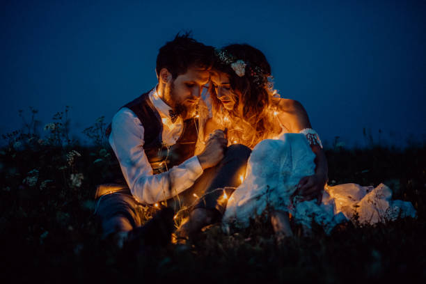 istock Beautiful bride and groom on a meadow at night. 851102782