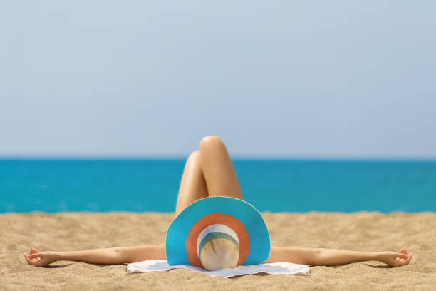 Relaxing and Sunbathing at Beach Relaxing and Sunbathing at Beach tanned body stock pictures, royalty-free photos & images