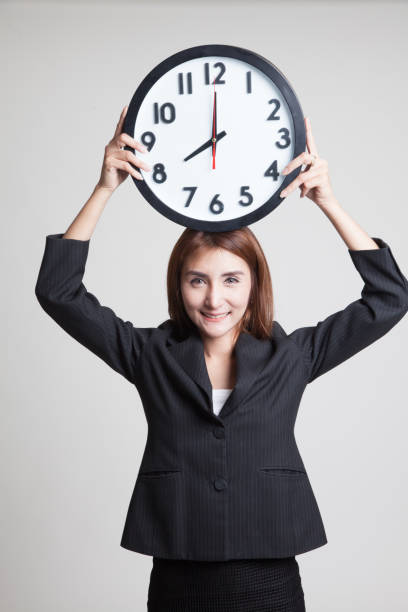 istock Young Asian business woman with a clock. 851111696