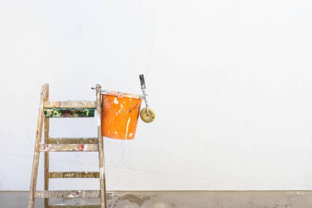 istock Ladder and house painter equipment against wall 851124806