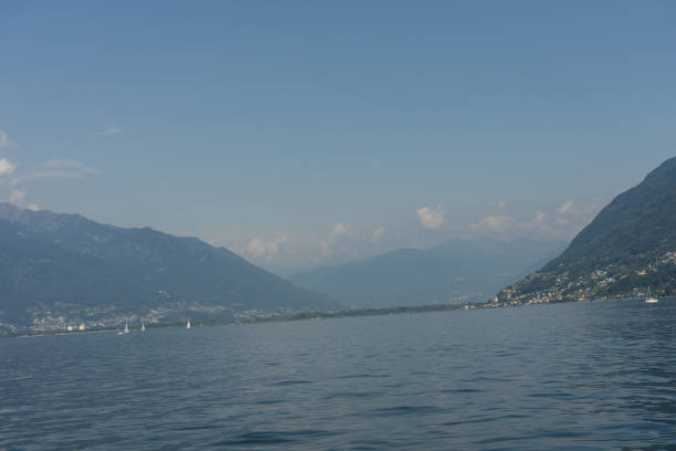istock lago maggiore lake scenery with mountain water and cloudy sky 851137926