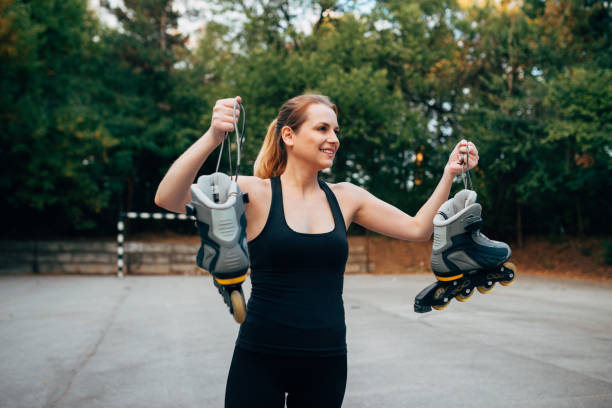 istock Young woman roller skating outdoors 851139282