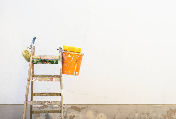 istock Stepladder and house painter equipment against wall 851148608