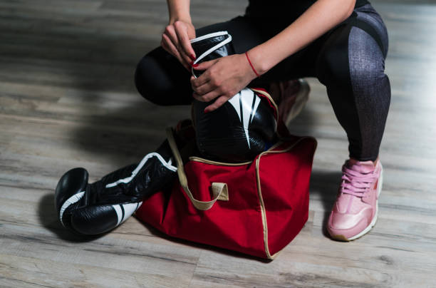 istock Young fighter boxer girl puting on boxing gloves before  trainin 851149038