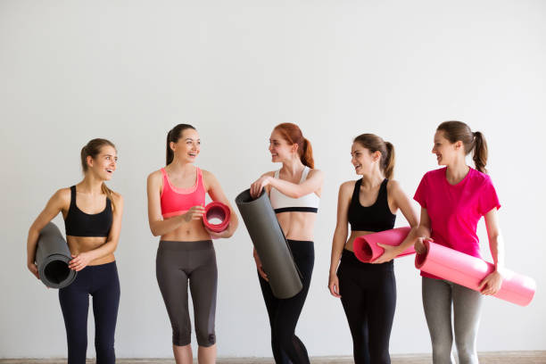 istock Young smiling woman with mats after yoga class. 851152234