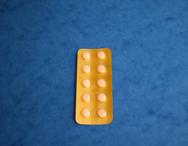 istock Gold colored medicine on the blue background 851155162