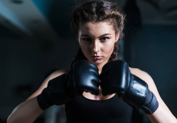 istock Young fighter boxer girl wearing boxing gloves before  training 851155800