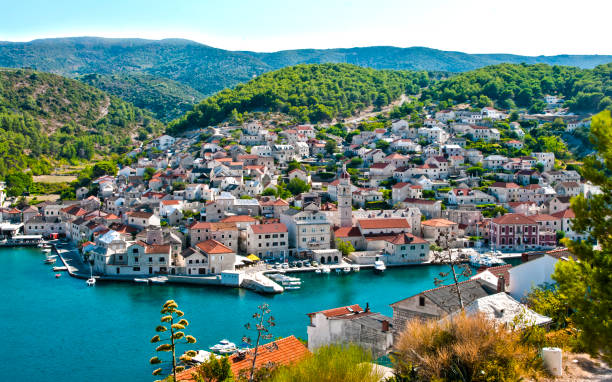 Pucisca - small croatian town on Brac island Pucisca, Croatia, Dalmatia - small romantic Croatian town located on the island of Brac, at the bay. Summer landscape with town and bay. Travel destination. brac island stock pictures, royalty-free photos & images