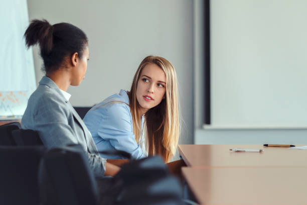 istock sSerious young businesswomen talking in office 851159544