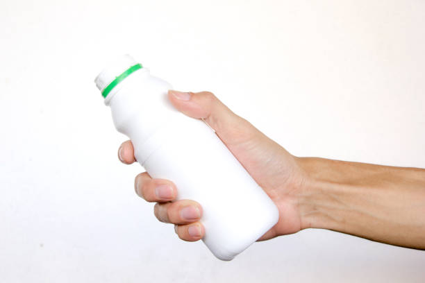 istock Hand holding open white bottle on white background. Hand gesture 851169398