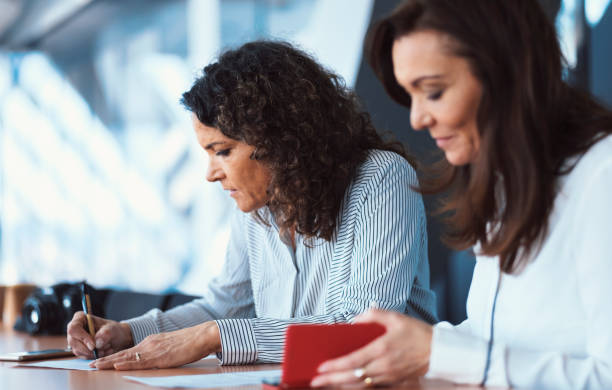 istock Businesswomen signing documents 851172300