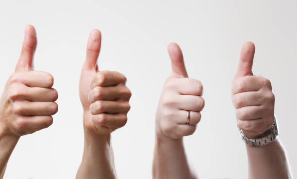 istock A group of people male hands on a gray background holds a thumb 851172932