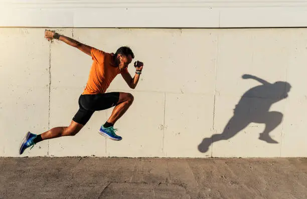 Photo of Handsome man running in the city.