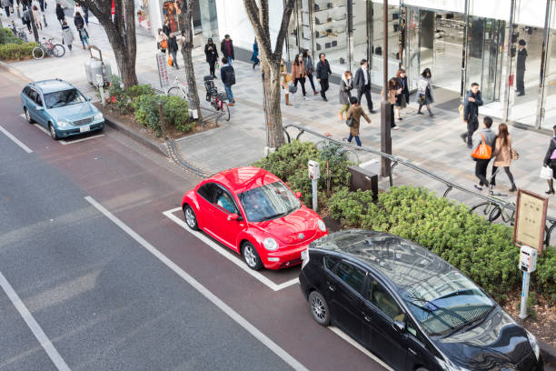 Bangkok, Thailand - February 15, 2014: Aerial shot of many VW Beetle oldtimer and some other VW oldtimer cars. Scene is during VW Siam meeting in Bangkok. Some Thai people are walking between cars of private people and are watching cars.