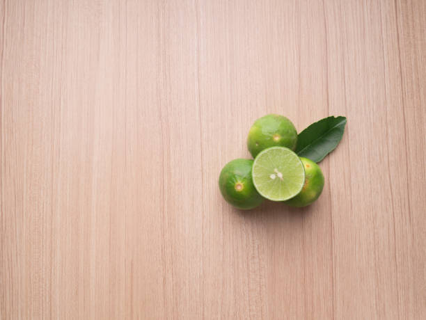 Lime on wood background, Top view stock photo