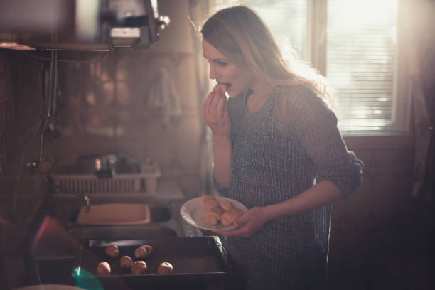 istock Beautiful young woman baking and eating pastries 851219616