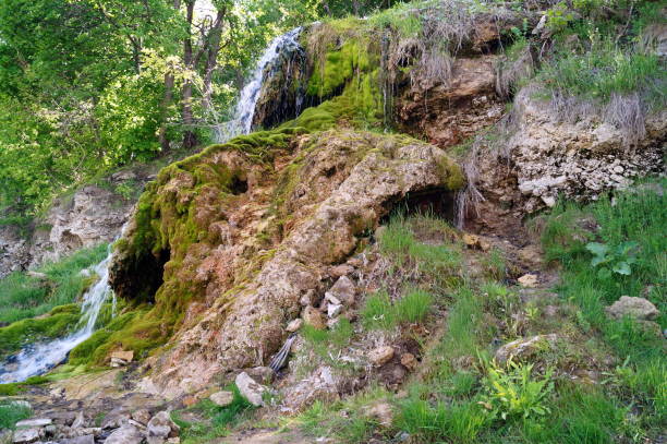 istock Stone wall with greenery and waterfall. Texture of nature. Background for text, banner, label. 851249282
