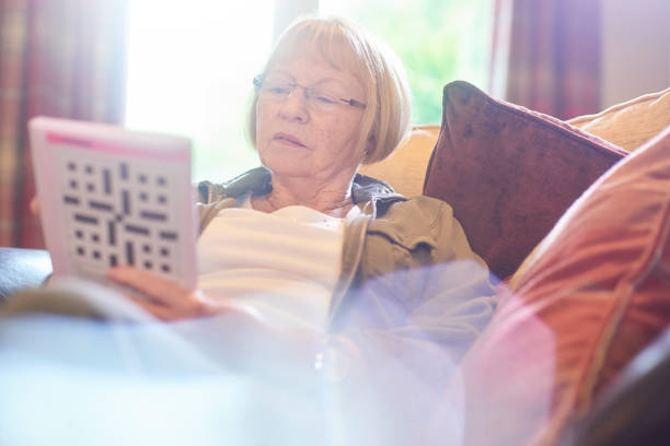istock senior woman doing crossword puzzle 851260506