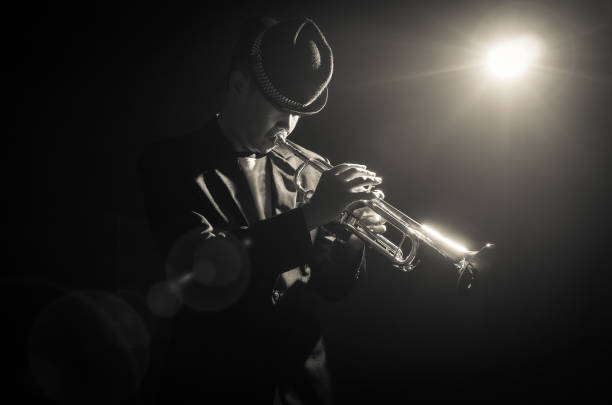 istock Musician playing the Trumpet with spot light on the stage 851331568
