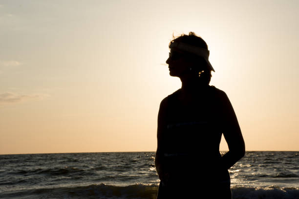 istock Silhouette of girl at sunset 851337564