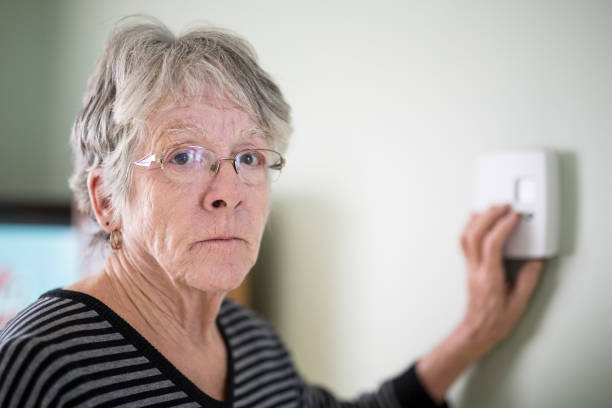 istock Senior woman adjusting her thermostat 851344194