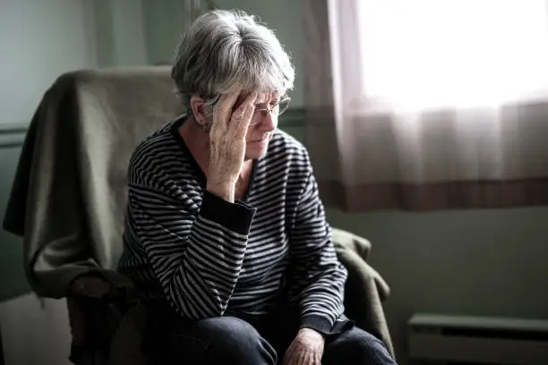 Photo of worried senior woman at home felling very bad