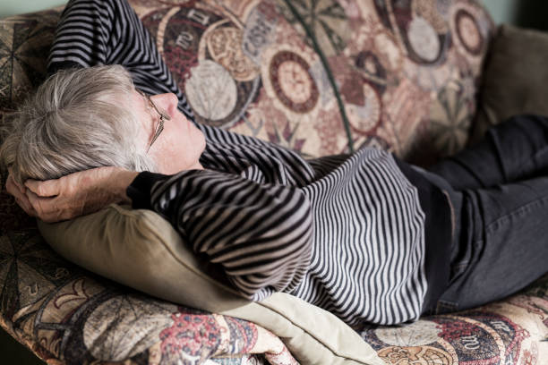 istock Senior woman relaxing on sofa 851347078