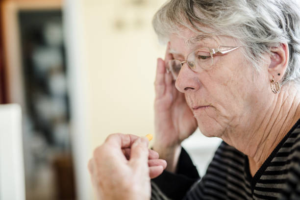 istock Sick senior woman taking her pills at home 851349592