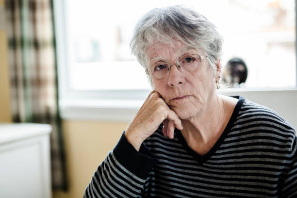 istock senior is sitting near the window in the kitchen 851349700