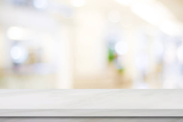 istock Empty white marble over blur store background, product and food display montage 851356346
