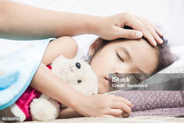 Mother Taking Care Asian Child Girl While She Sleeping In The Bed Stock Photo - Download Image Now