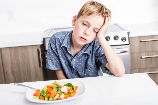 boring expression with fresh colorful vegetables child