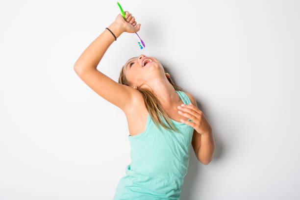 Cute little girl brushing teeth, isolated on white