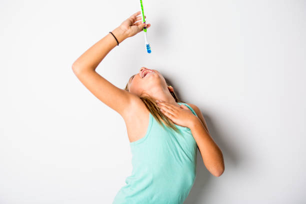 istock Cute little girl brushing teeth, isolated on white 851393680