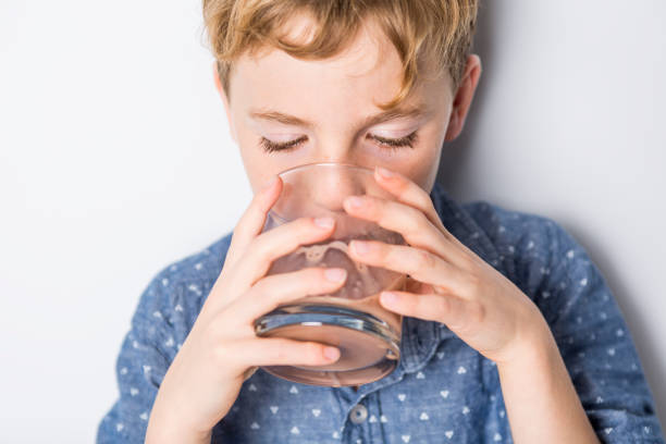 istock Happy smiling child drinking chocolate milk isolated on white 851393846