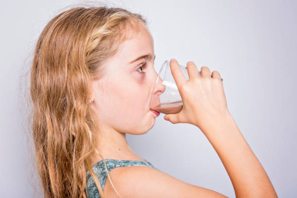 istock Happy smiling child drinking chocolate milk isolated on white 851393958