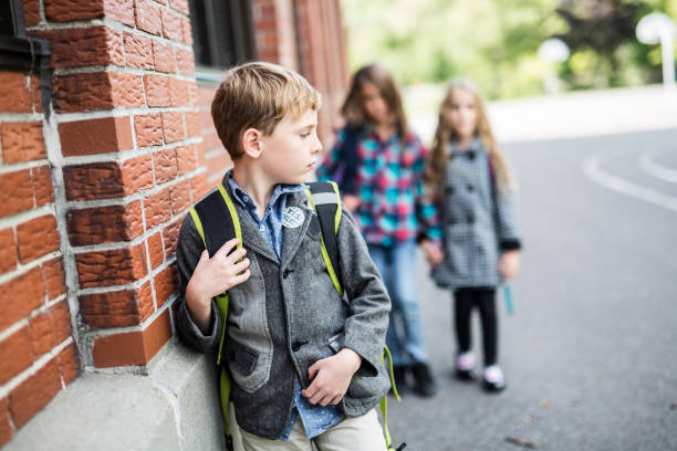 istock Pupils friends teasing a pupil alone primary school 851416756