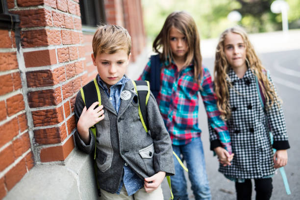 istock Pupils friends teasing a pupil alone primary school 851416776