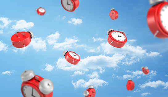 3d rendering of a many red retro-looking alarm clocks with metal bells fall down on cloudy sky background. All time in life. Schedule and planning. Important things to do.