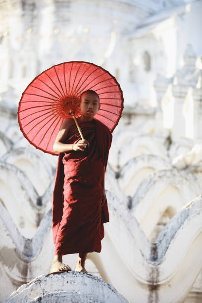istock Novices under umbrellas at historic temple, Mingun 851423458