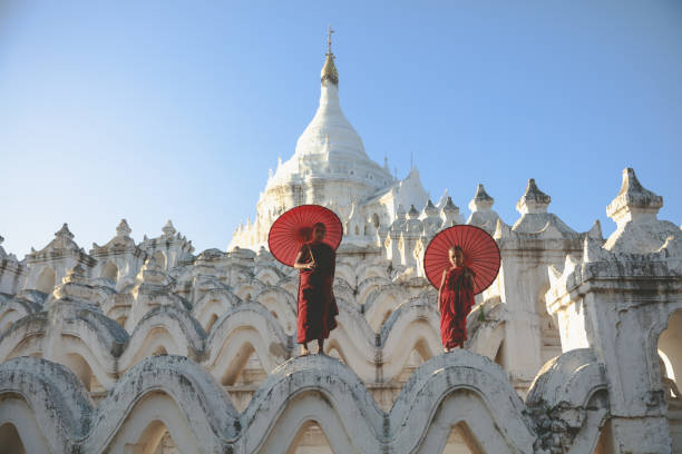 istock Novices under umbrellas at historic temple 851423460