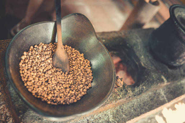 istock Old Traditional Way of Roasting Raw Coffee Beans on Fire 851428854