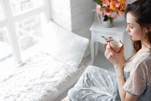 istock Sensual young woman with cup of tea 851442556
