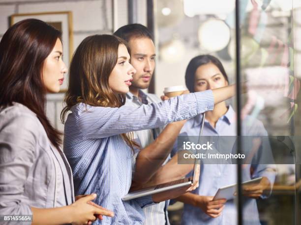 Asian And Caucasian Businesspeople Meeting In Office Stock Photo - Download Image Now
