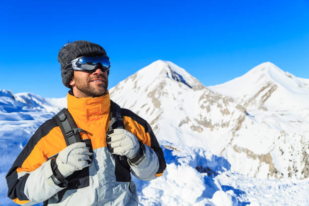 istock Male backpacker hiking in snow mountain 851459440
